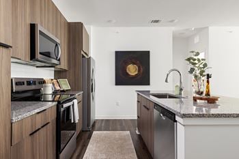 A modern kitchen with a dark wood finish.